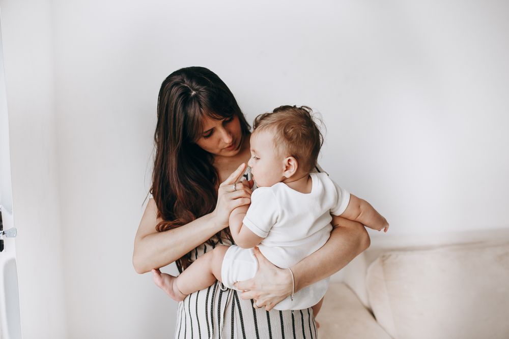 Parent holding a baby at home